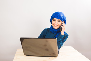 Beautiful young muslim business woman with laptop in office
