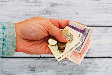 Male hand in old jacket holding money of Bulgaria