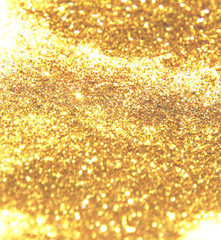 Beautiful blurry golden background with glitter