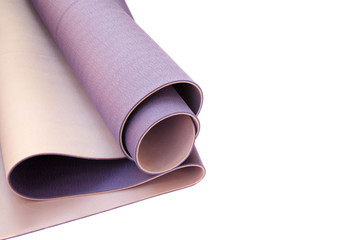 Accessories for practicing yoga or pilates. Rolled lilac exercise mat on white background. Isolated image. Active lifestyle, sport concept.