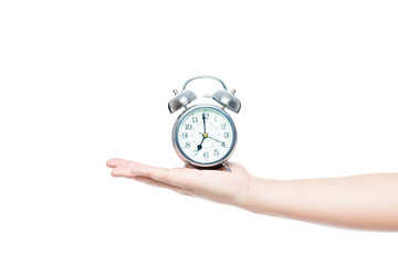 man's hand on a white background isolated with an alarm clock in retro style