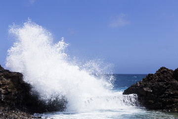 Blue waves crashing on a rocky shore. atlantic ocean. summer. windy. Lanzarote, Canary Islands