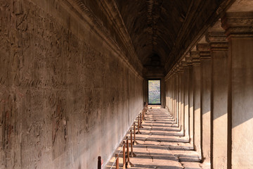 corridor of Angkor wat temple with carvings status on the wall, world heritage, Siemreap, Cambodia