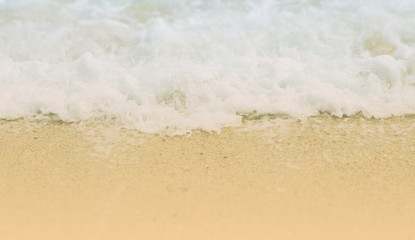 Fototapeta na wymiar Wave on sand with tilt shift effect selective focused on wave