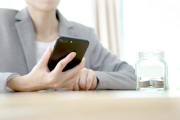 Businesswoman hid behind a jar full of coins