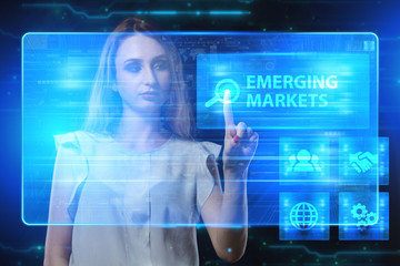 The concept of business, technology, the Internet and the network. A young entrepreneur working on a virtual screen of the future and sees the inscription: Emerging markets