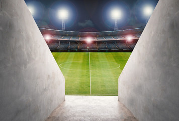 tunnel in stadium with green field © phonlamaiphoto