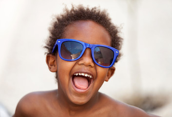 Funny Afro-American kid with blue sunglasses