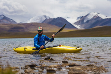 Kayaking on a high mountain lake. Kyrgyzstan.