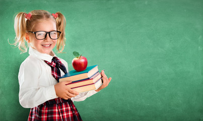 Little Schoolgirl Holding Books And Apple