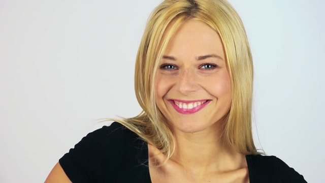 A young attractive woman strikes poses - face closeup - white screen studio