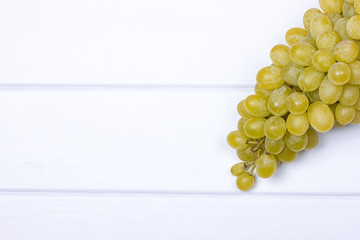 White grapes on white wooden surface