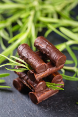 Homemade chocolate candy sticks with rosemary