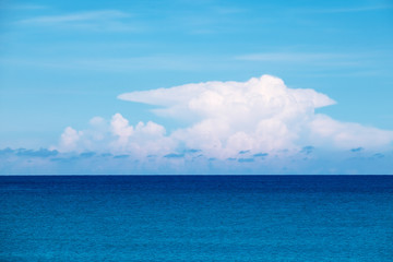 Naklejka na ściany i meble Blue sea with big white clouds and sky.