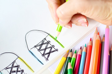 Person drawing with colored pencils for school.  Art shown in color.