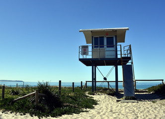 Fototapeta na wymiar Blacksmiths, Australia - Aug 13, 2017. Surf Life Saving Lookout Tower at Blacksmiths beach. It is a patrolled beach at the southern end of a sandy nine mile stretch of coastline.