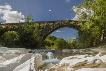 The ancient Ponte del Casotto bridge in Pontremoli, Massa Carrara, Italy, with in the foreground a...