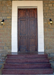 house facade with stone walls and old wooden door