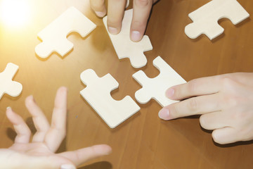 Business partnership or teamwork concept with a business people presenting a matching puzzle piece...