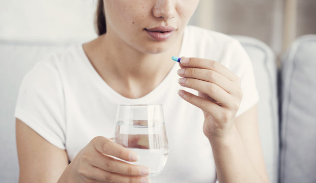 Young Woman Taking Pill