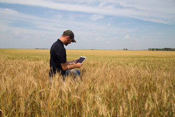 Agronomist with a Tablet in an Agricultural Field