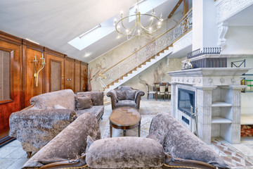 Russia,Moscow - modern living room interior. Duplex apartment with a stylish spiral staircase.