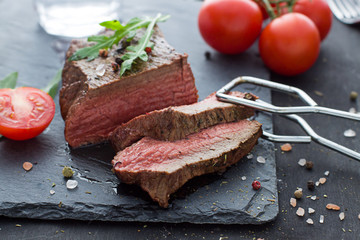 Beef steak on the dark plate. Close up