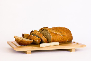 Rye bread with cereals on wooden table. Isolated