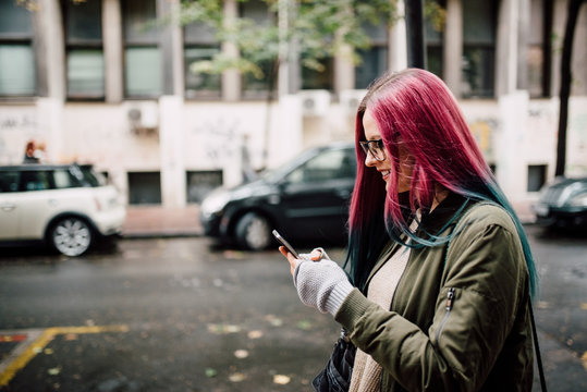 Young woman using her cellphone outdoor