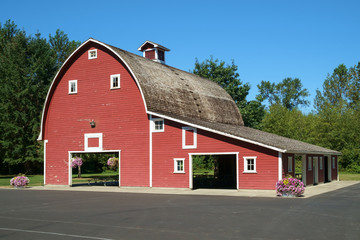 Red barn with flowers