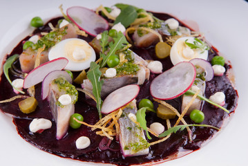 Sliced herring and radishes with sauce