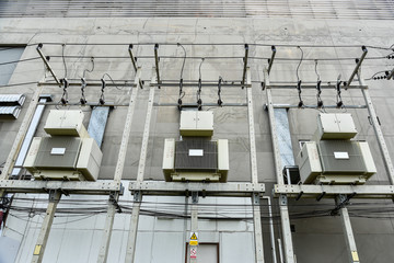 Electric transformer with cooling ribs at factory. Industrial infrastructure. Electrical energy. Energy concept.