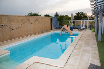 A woman plunges into the family pool