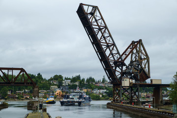 Fototapeta na wymiar Ferry M/V Susitna passing below Salmon Bay Bridge
