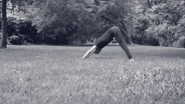 A man doing yoga exercises in the park