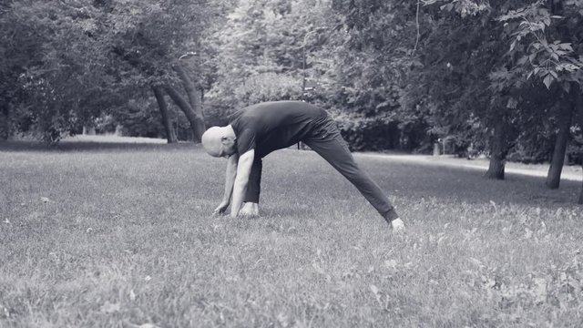 A man doing yoga exercises in the park