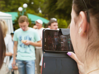 Girl smartphone shoots video in parke contest, holiday, youth