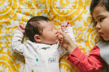 Big brother with newborn baby sister