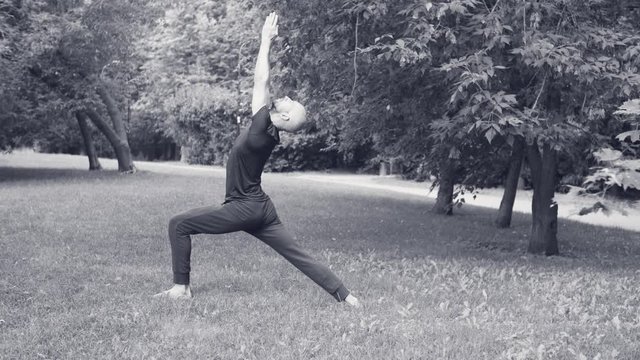 A man doing yoga exercises in the park