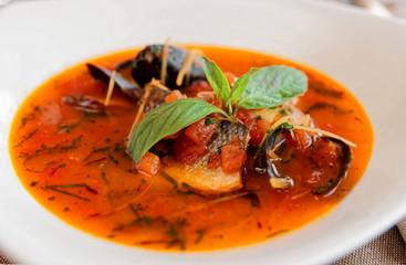 Seafood soup in porcelain plate, toned