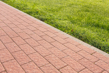 road and lawn divided by a concrete curb