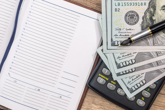 empty notepad, pen, doolar and coin on desk