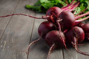 Bunch of fresh organic beets on rustic wooden table, selective focus, copy space