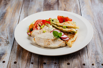 Turkey cutlets served with vegetables, pita bread with pesto and cream sauce. Copy space