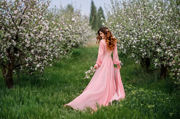 Obraz na płótnie Canvas Pretty woman in a beautiful dress outdoor