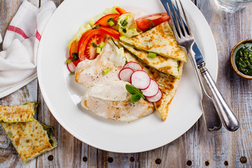 Turkey cutlets served with vegetables, pita bread with pesto and cream sauce. Copy space