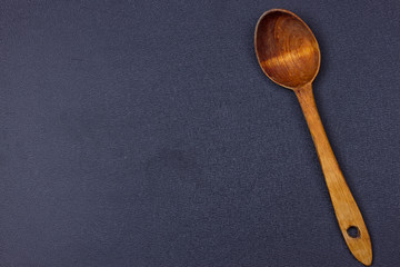 wooden spoon on black background