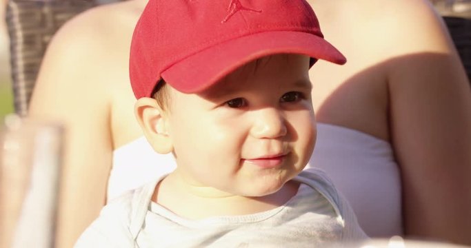 Toddler on mothers lap smiles and laugh
