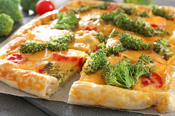 Traditional quiche with broccoli and cheese on table