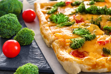 Traditional quiche with broccoli and cheese on table, close up